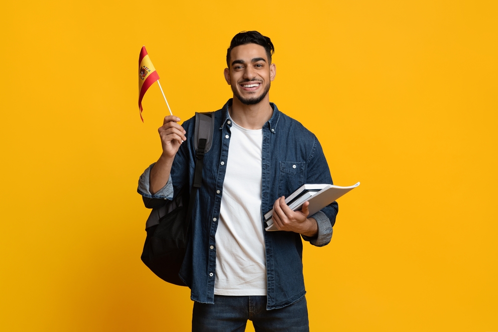 International student holding the Spanish flag